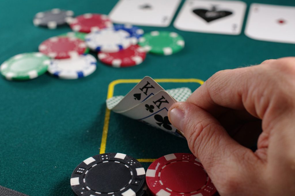 Poker playing showing his hand containing 2 kings